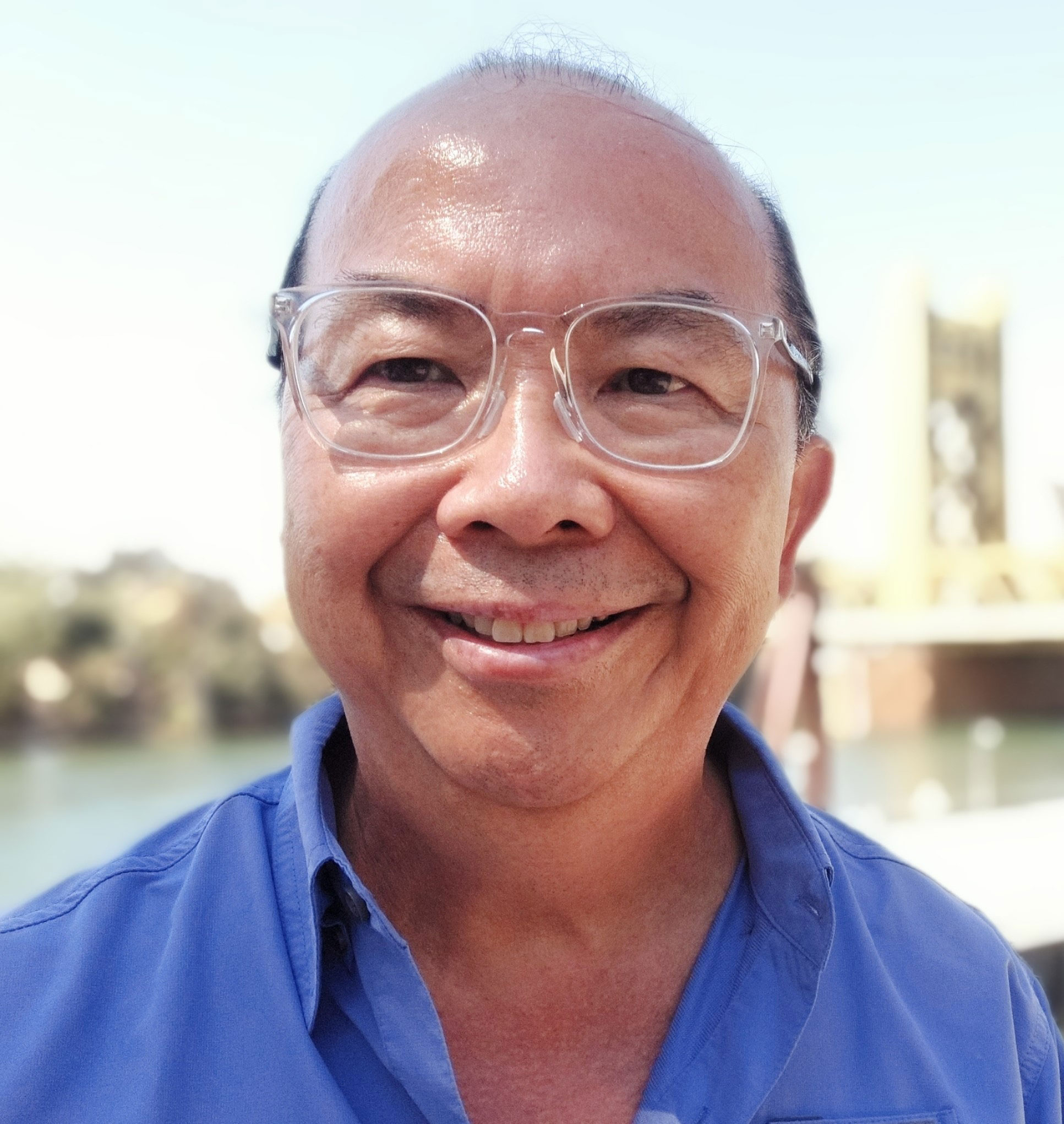 Photo of Morris Lum by Sacramento River and with Tower Bridge in background