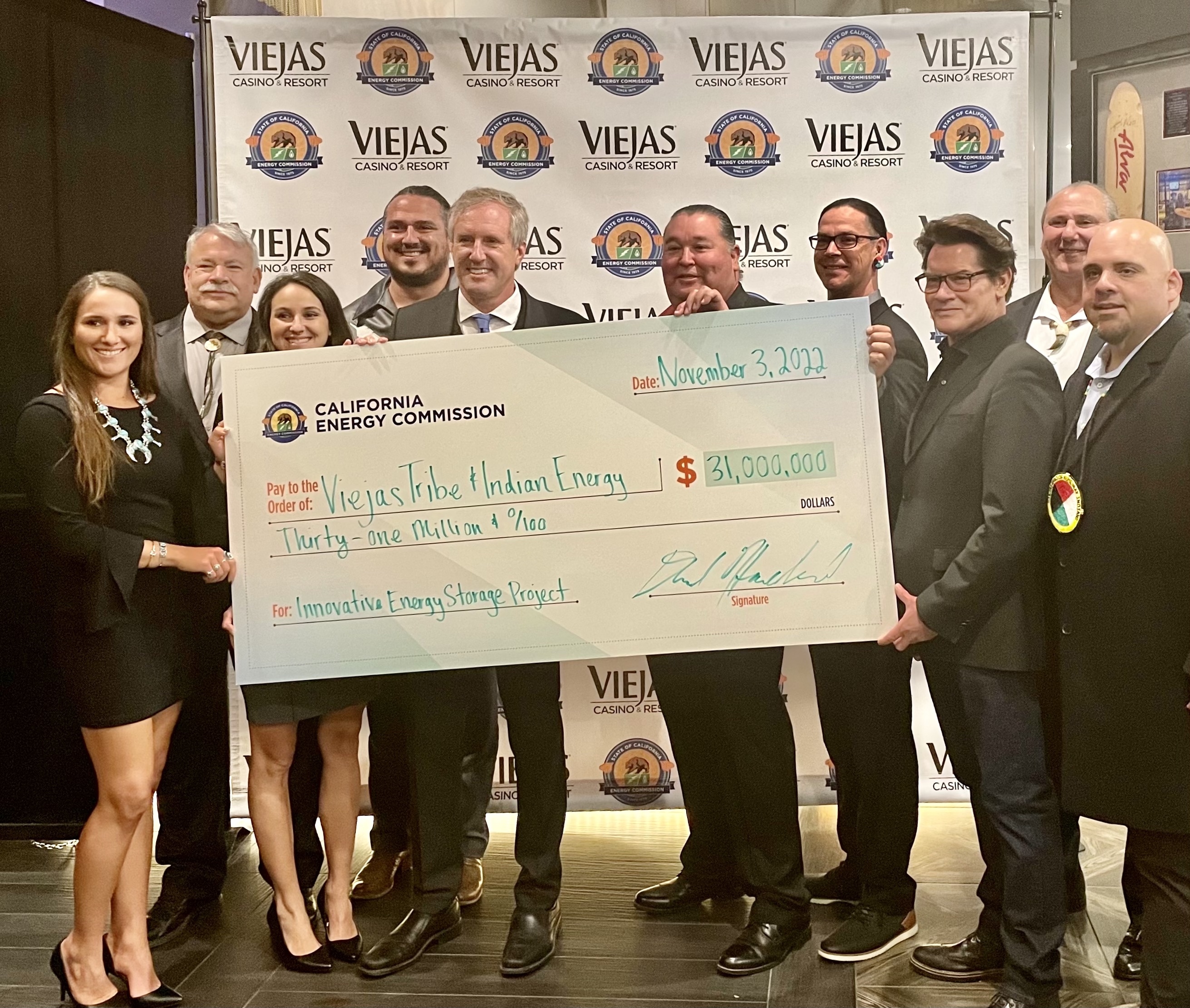 Image of Chair David Hochschild, Viejas Tribal officials and Indian Energy representatives holding an oversized check for $31 million for an innovative energy storage project.