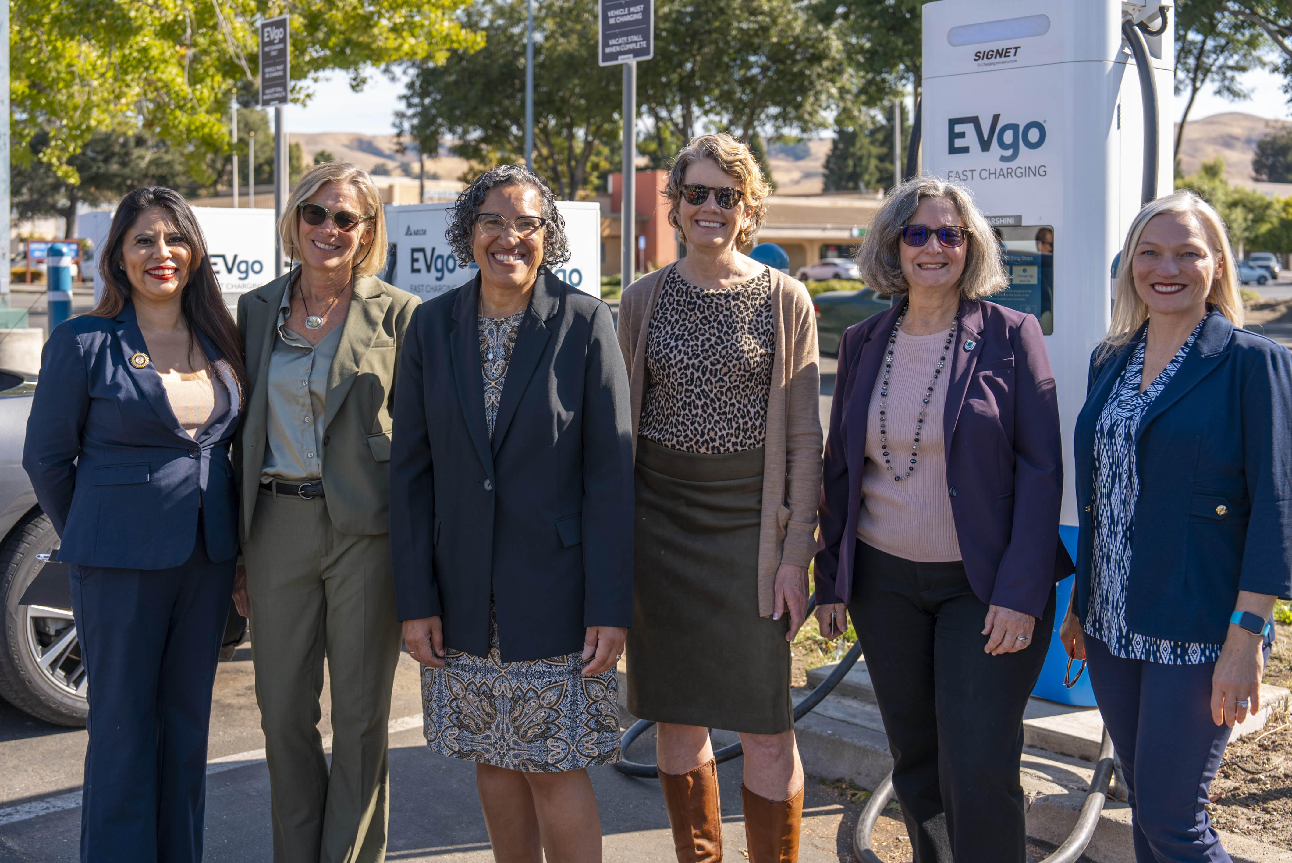 Image of CA Leaders Celebrate Surpassing 10k Fast Charger Goals in a parking lot.
