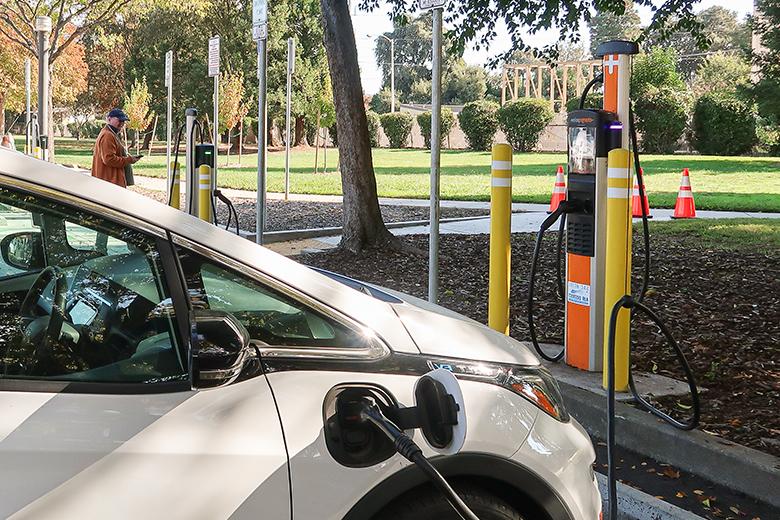 Image of an electric vehicle plugged into a charging station.