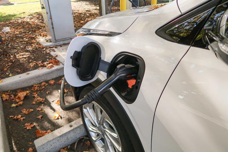 EV charger plugged into a white vehicle.