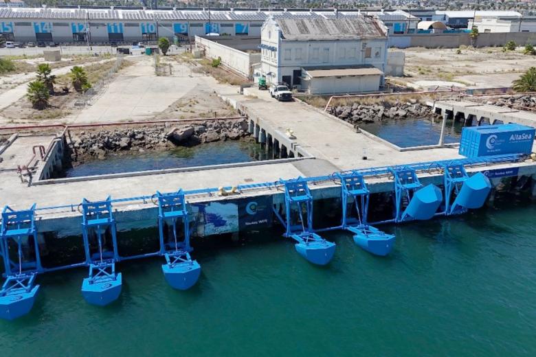 This image depicts the first onshore wave energy project in the United States, installed at the Port of Los Angeles. This 100-kilowatt pilot project developed by Eco Wave Power consists of seven wave energy converters attached to an existing wharf to capture wave motion, which is then converted into electricity.